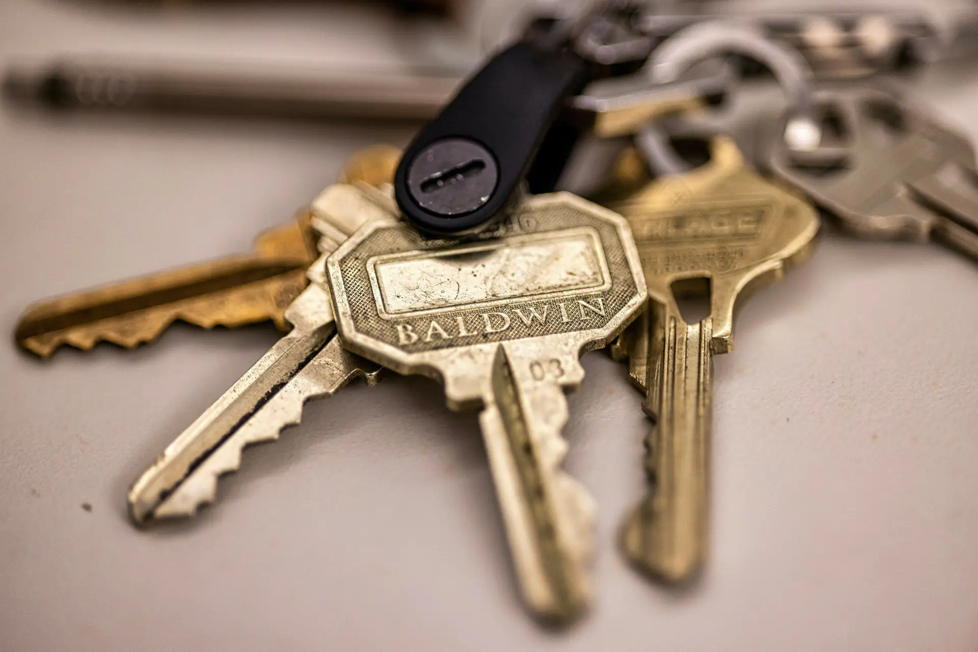 A ring of brass house keys on a table
