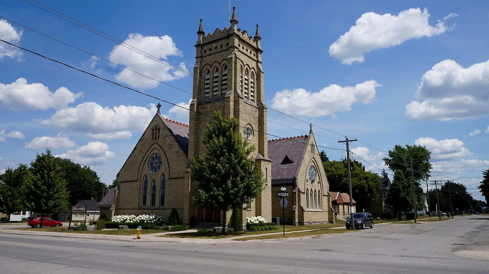 The buff-brick Trivitt Memorial Church and its spire in Exeter
