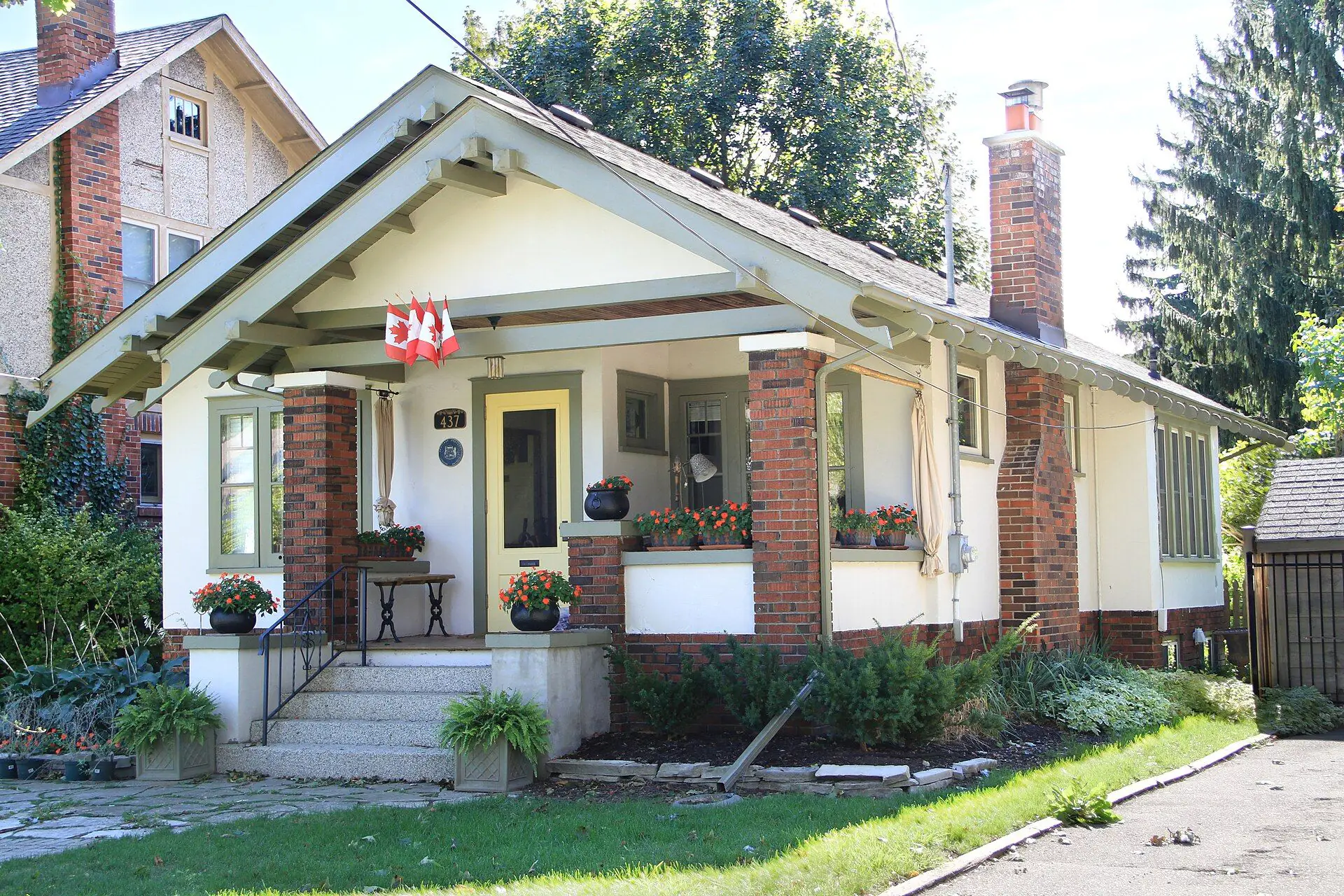 A craftsman bungalow with brick porch piers and flower boxes on Victoria Street in Old North