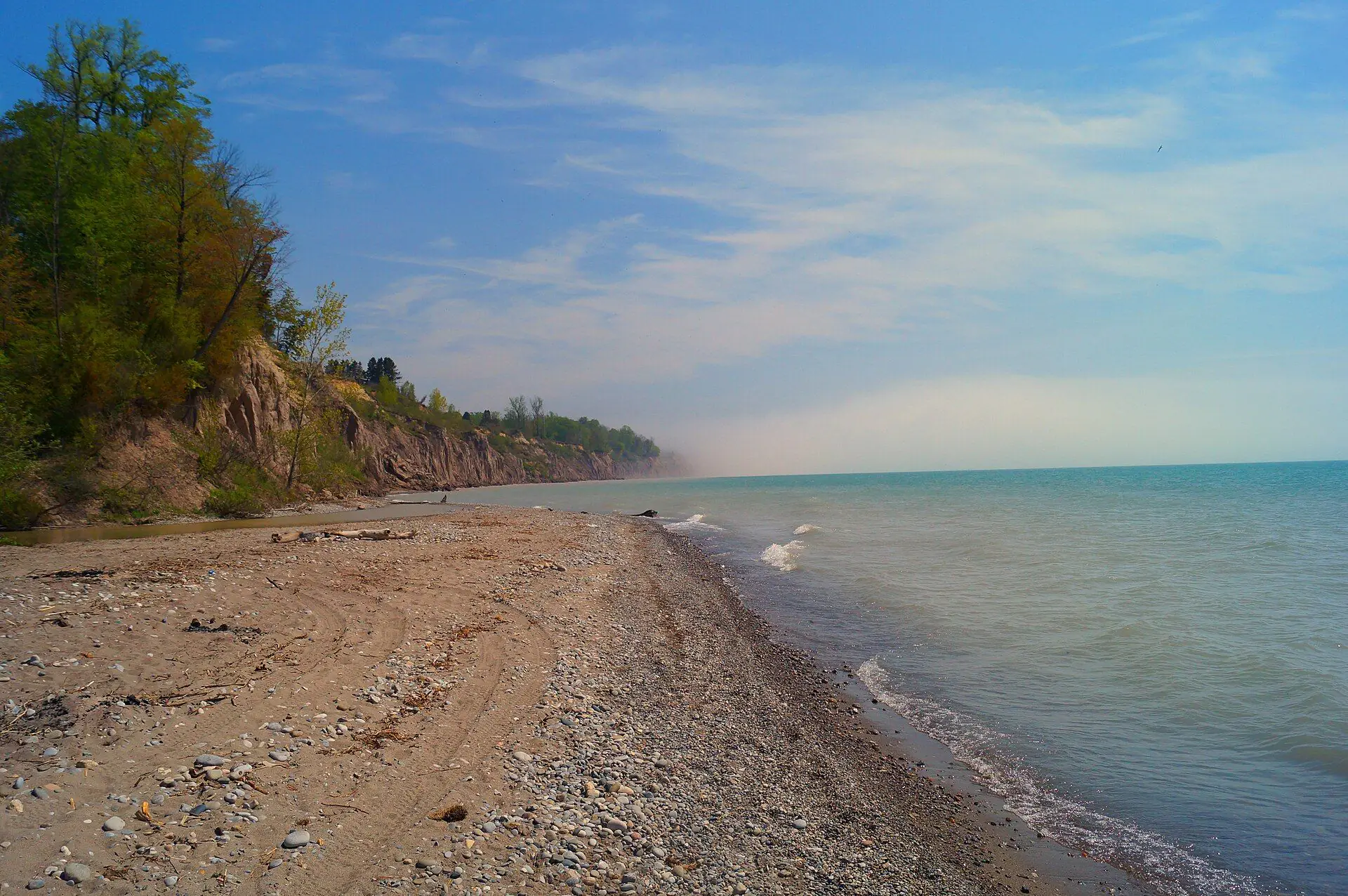 A sand beach below wooded clay bluffs at Tyrconnell on Lake Erie
