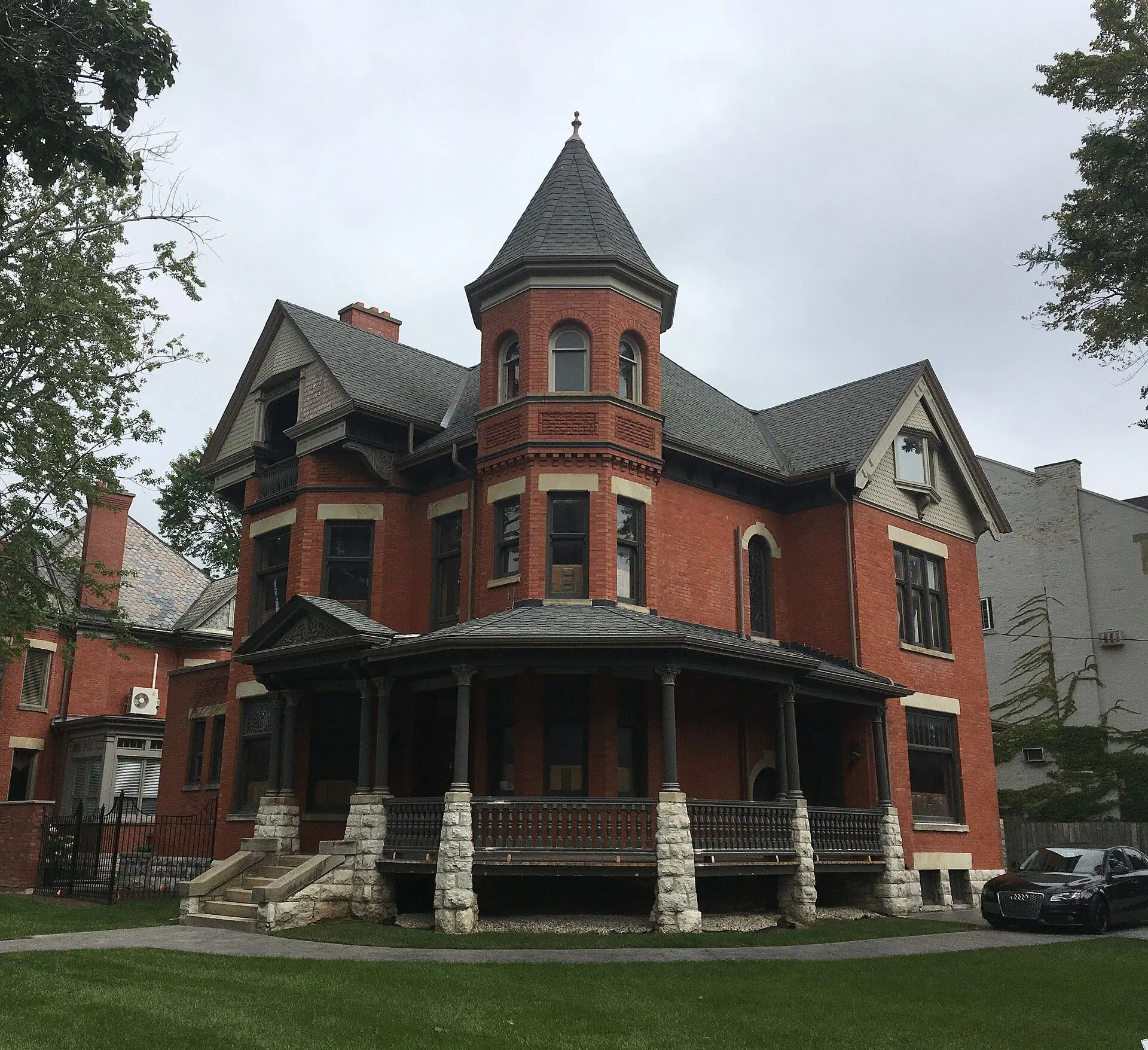 A red-brick Queen Anne house with a turret and wraparound porch on Waterloo Street