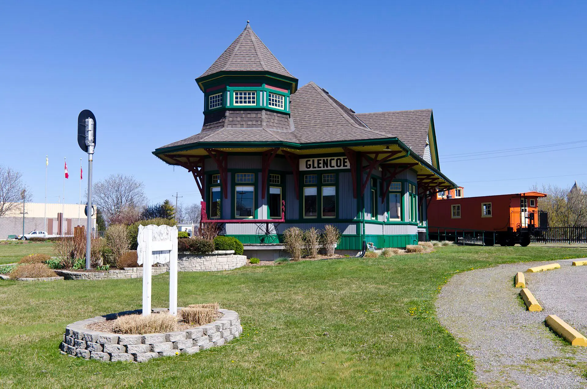 The Queen Anne Revival railway station in Glencoe under a blue spring sky