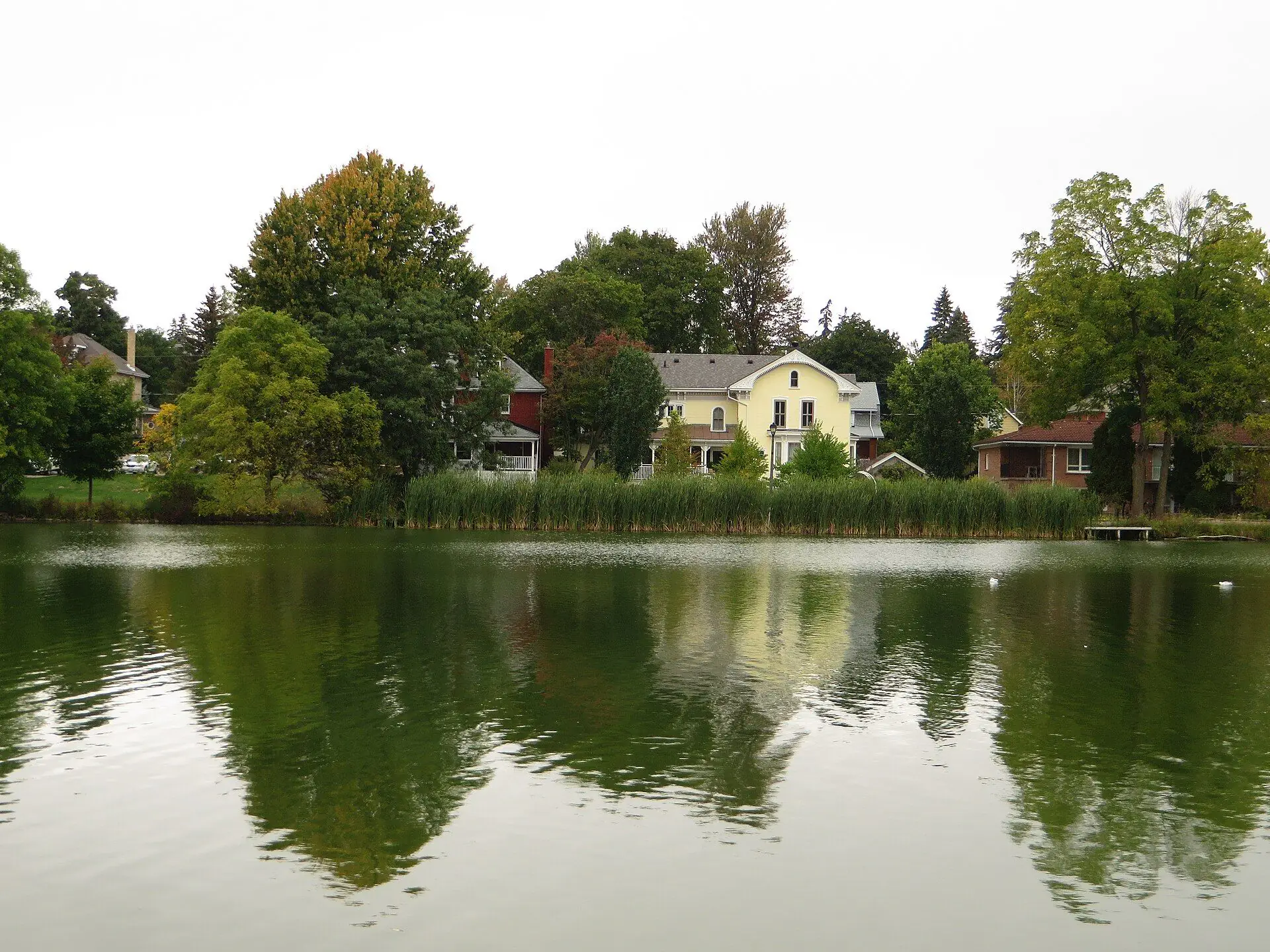 Homes and trees reflected in the Avon River in Stratford